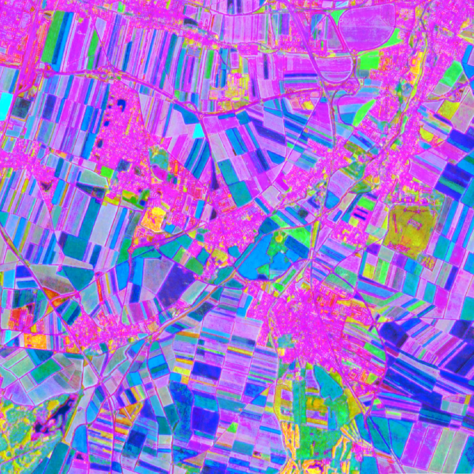 A false-colour TESSERA embedding map of farmland northeast of Vienna, Austria, showing sharp-edged agricultural fields in blues, greens and purples set against a magenta backdrop of built-up areas and roads